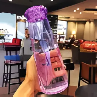 "Transparent crystal glass water bottle with infuser compartments for fruit and herbal drinks, designed for healthy hydration"