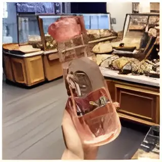 "Transparent crystal glass water bottle with infuser compartments for fruit and herbal drinks, designed for healthy hydration"
