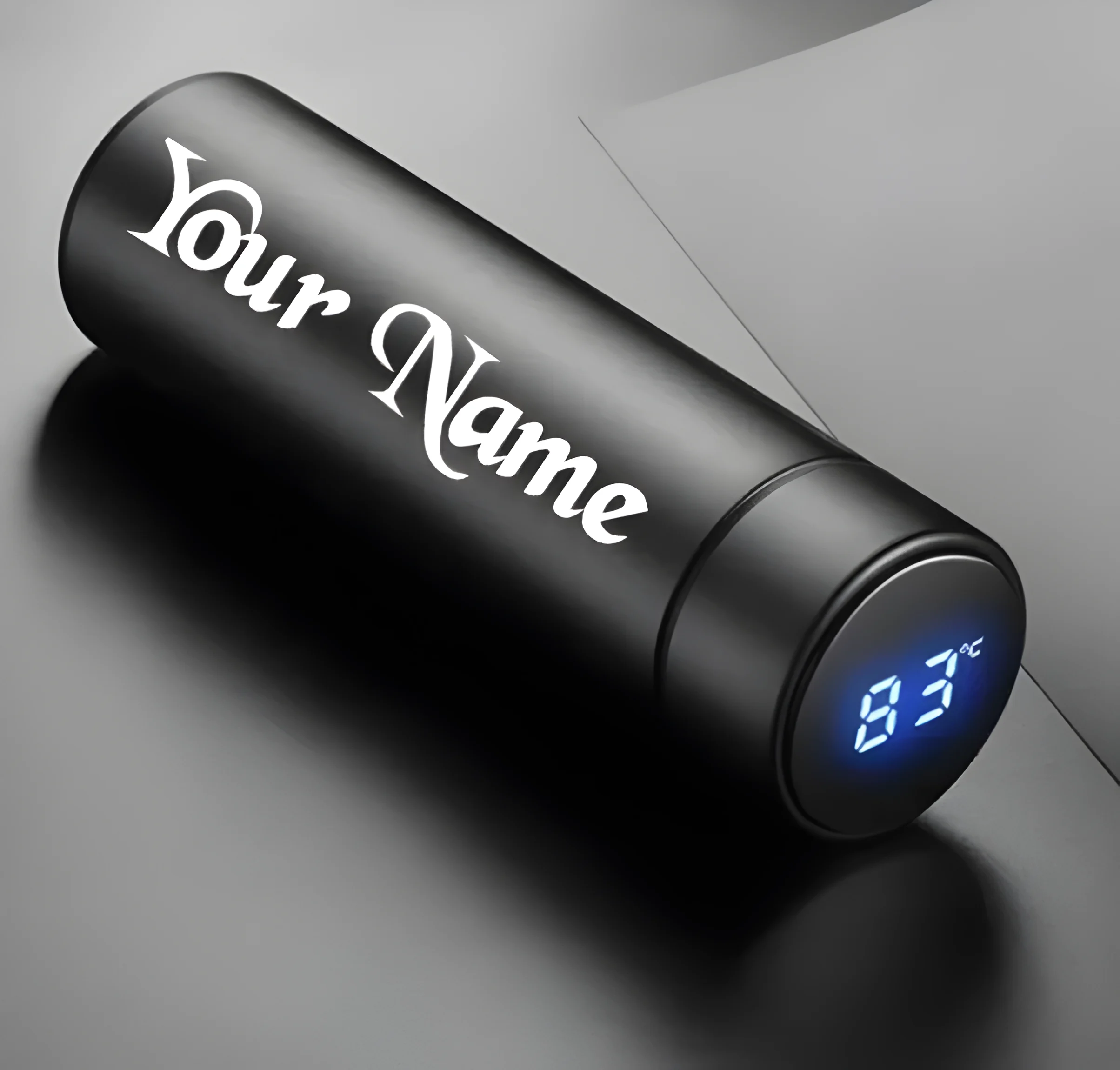 "Black custom stainless steel smart water bottle with personalized name engraving and digital temperature display on lid."